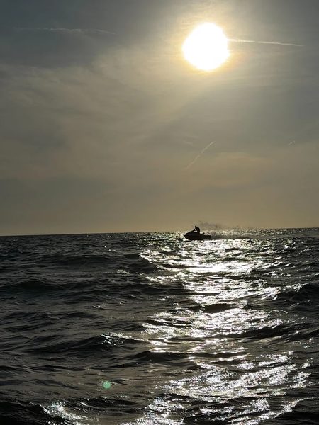 PWC silhouette on the Gulf of America at sunset